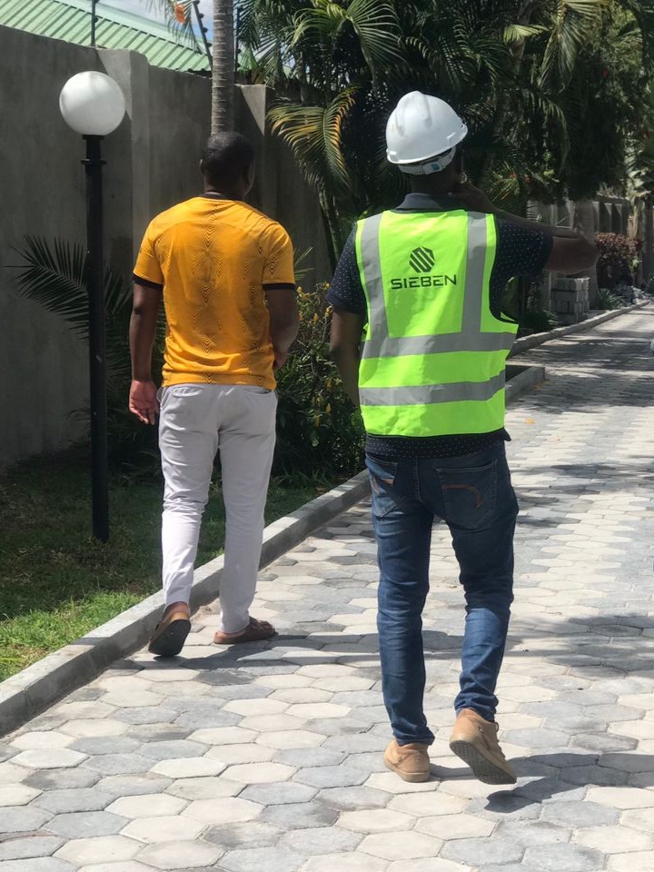 Sieben Construction team member walking a client through a completed project in Lusaka, Zambia